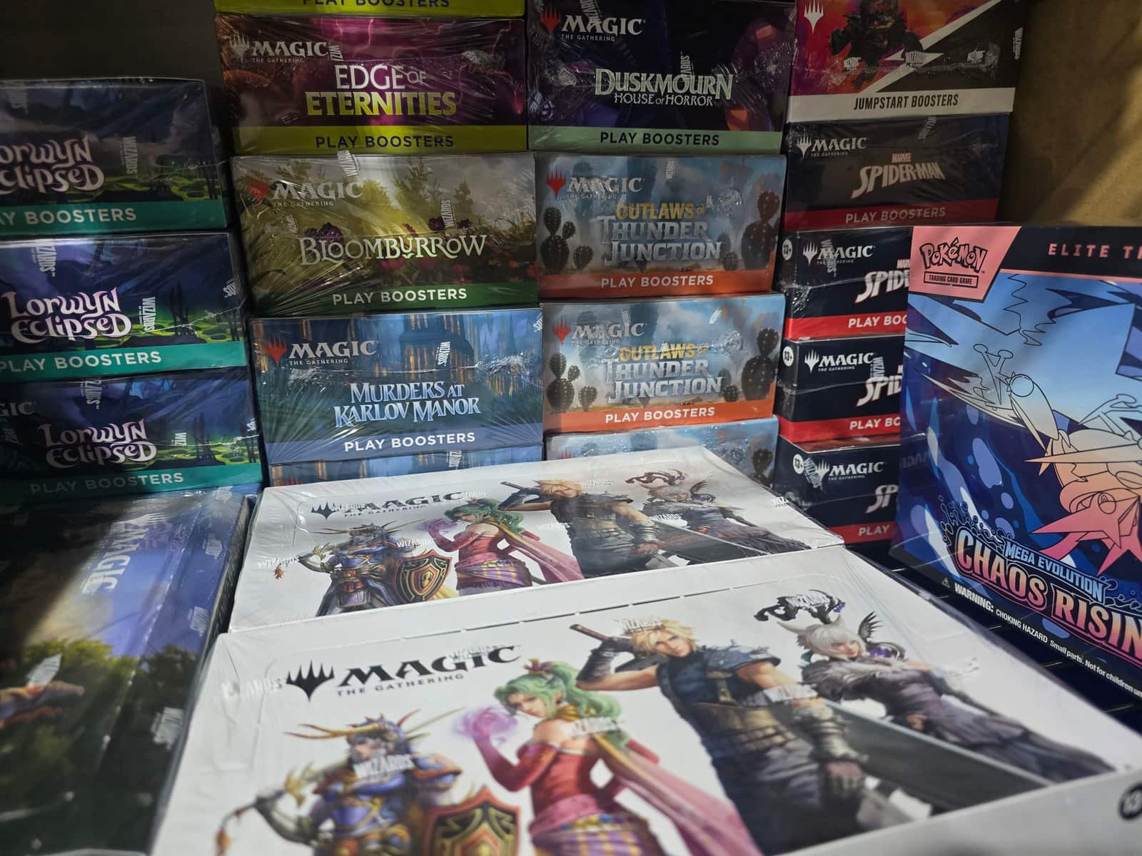 Commander's Cache sealed inventory: Magic: The Gathering booster boxes and a Pokemon Elite Trainer Box